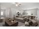 Open-concept living room and kitchen featuring modern furnishings and stainless steel appliances at 154 Taverners Ln, Angier, NC 27501
