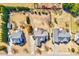 Aerial view of homes featuring large lots, mature trees, and backyard play equipment at 1624 Struble Cir, Willow Springs, NC 27592