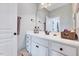Well-lit bathroom featuring a vanity with white cabinets and modern fixtures at 1624 Struble Cir, Willow Springs, NC 27592