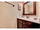 Cozy bathroom featuring a dark wood vanity with framed mirror and a sink at 1624 Struble Cir, Willow Springs, NC 27592