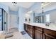 Spacious bathroom with double vanity, large mirror, shower, and decorative light fixtures at 1624 Struble Cir, Willow Springs, NC 27592