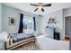 Bedroom with a window, a blue dresser, a ceiling fan, and a patterned area rug at 1624 Struble Cir, Willow Springs, NC 27592