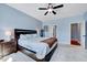 Bedroom featuring light blue walls, a dark wooden bed, a ceiling fan, and white carpeted flooring at 1624 Struble Cir, Willow Springs, NC 27592