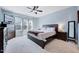 Cozy bedroom with blue walls, ceiling fan, carpeted floors, and windows for natural light at 1624 Struble Cir, Willow Springs, NC 27592