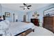 Bedroom with blue walls, white carpet, ceiling fan, television, and doorway to another room at 1624 Struble Cir, Willow Springs, NC 27592