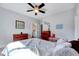 Bright bedroom featuring two dressers, a ceiling fan, and a colorful bedspread at 1624 Struble Cir, Willow Springs, NC 27592