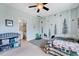 Bright, decorated bedroom with playful wall art and ceiling fan at 1624 Struble Cir, Willow Springs, NC 27592