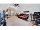 Bonus room with a comfortable couch, ceiling fan, and a great space for relaxing and entertaining at 1624 Struble Cir, Willow Springs, NC 27592