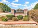 Bloomfield entrance featuring natural stone sign and lush green landscaping on a sunny day at 1624 Struble Cir, Willow Springs, NC 27592