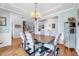 Elegant dining room with a chandelier, adjacent to living spaces, and detailed trim work at 1624 Struble Cir, Willow Springs, NC 27592