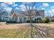 Traditional home with a covered front porch, stone accents, tidy landscaping, and a well-maintained front lawn at 1624 Struble Cir, Willow Springs, NC 27592