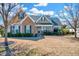 Charming two-story home with a mix of stone and siding, a well-maintained lawn and mature trees at 1624 Struble Cir, Willow Springs, NC 27592