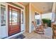 Inviting covered porch with two rocking chairs and stone flooring at 1624 Struble Cir, Willow Springs, NC 27592
