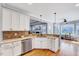 Well-lit kitchen area with granite countertops, tiled backsplash, and stainless steel dishwasher at 1624 Struble Cir, Willow Springs, NC 27592
