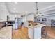 Expansive kitchen showcasing granite counters, stainless steel appliances, and hardwood floors at 1624 Struble Cir, Willow Springs, NC 27592