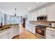 Open kitchen with stainless steel appliances, granite counters, and tiled backsplash at 1624 Struble Cir, Willow Springs, NC 27592