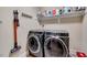 Laundry room with modern, stainless steel, front loading washer and dryer at 1624 Struble Cir, Willow Springs, NC 27592