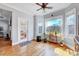 Hardwood floors, natural light, and large windows illuminate the sunroom at 1624 Struble Cir, Willow Springs, NC 27592