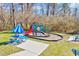 Community playground with colorful play equipment and seating area at 1624 Struble Cir, Willow Springs, NC 27592