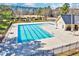 Community pool with sun loungers and clubhouse for residents' enjoyment at 1624 Struble Cir, Willow Springs, NC 27592