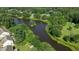 Scenic aerial view of lake surrounded by lush greenery and beautiful homes in a tranquil neighborhood at 2120 Rainy Lake St, Wake Forest, NC 27587