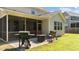 Well-maintained backyard with a screened porch, outdoor seating area, and lush green lawn at 2120 Rainy Lake St, Wake Forest, NC 27587