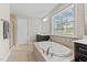 Elegant bathroom features a large soaking tub with tile surround and a walk-in shower at 2120 Rainy Lake St, Wake Forest, NC 27587