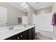 Bright bathroom featuring a double sink vanity and bathtub with tiled floors at 2120 Rainy Lake St, Wake Forest, NC 27587