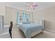 Bedroom with a ceiling fan, dresser, and natural light from the two windows at 2120 Rainy Lake St, Wake Forest, NC 27587
