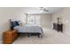 Spacious bedroom with a queen-sized bed, ceiling fan, and view of the neighborhood at 2120 Rainy Lake St, Wake Forest, NC 27587
