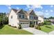 Side view of the lovely home with a well-manicured lawn and mature landscaping at 2120 Rainy Lake St, Wake Forest, NC 27587