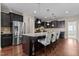 The kitchen offers stainless appliances, dark cabinetry, granite countertops, and hardwood flooring at 2120 Rainy Lake St, Wake Forest, NC 27587