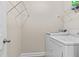 Well-equipped laundry room with modern appliances and overhead storage at 2120 Rainy Lake St, Wake Forest, NC 27587