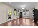 Bright, airy living room featuring hardwood floors, natural light, and a view of the backyard at 2120 Rainy Lake St, Wake Forest, NC 27587