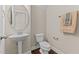 A clean powder room with pedestal sink, oval mirror, and neutral wall color at 2120 Rainy Lake St, Wake Forest, NC 27587