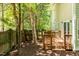 A wooden deck overlooks the beautiful treed back yard with fencing and landscaping at 219 W Columbia Pl, Chapel Hill, NC 27516