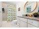 Well-lit bathroom with granite countertop, decorative mirror, and tile flooring at 219 W Columbia Pl, Chapel Hill, NC 27516