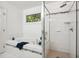 Bright bathroom featuring a soaking tub and glass shower at 219 W Columbia Pl, Chapel Hill, NC 27516