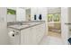 Bright bathroom featuring a double vanity and a large mirror at 219 W Columbia Pl, Chapel Hill, NC 27516