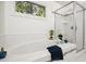 Bathroom featuring a soaking tub and a glass shower with natural light at 219 W Columbia Pl, Chapel Hill, NC 27516