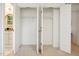 Bedroom closet featuring a double door with built-in shelving for efficient storage at 219 W Columbia Pl, Chapel Hill, NC 27516