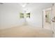 Bright, carpeted bedroom with ceiling fan and natural light from two windows at 219 W Columbia Pl, Chapel Hill, NC 27516