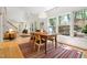 Sun-filled dining room with light wood floors, white walls, and a decorative pendant light above the dining table at 219 W Columbia Pl, Chapel Hill, NC 27516
