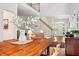 Open-concept home featuring a staircase, a dining room table with flowers, and views of the front entryway at 219 W Columbia Pl, Chapel Hill, NC 27516