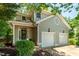 Charming two-story home featuring a two-car garage, arched front door and mature landscaping at 219 W Columbia Pl, Chapel Hill, NC 27516