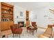 Living room featuring fireplace, built-in shelves, hardwood floors and two chairs at 219 W Columbia Pl, Chapel Hill, NC 27516