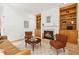 Bright living room features fireplace, built-in shelves, hardwood floors and leather sofa at 219 W Columbia Pl, Chapel Hill, NC 27516
