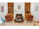 Cozy fireplace with built-in shelves and comfortable seating in the living room at 219 W Columbia Pl, Chapel Hill, NC 27516