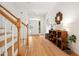 Bright foyer with hardwood floors, white walls, and a staircase with wood railing at 219 W Columbia Pl, Chapel Hill, NC 27516
