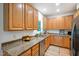 Well-lit kitchen featuring light wood cabinets, granite counters, stainless steel appliances and a sink with a window at 219 W Columbia Pl, Chapel Hill, NC 27516